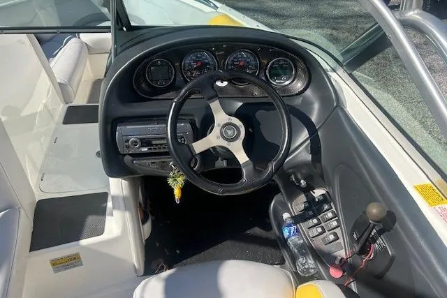 Slide: The Image of 2004 Centurion Lightning boat dashboard with steering wheel and control panel. - 10