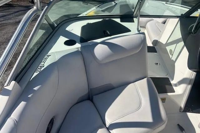 Slide: The Image of 2004 Centurion Lightning boat interior with white cushioned seating and sleek design. - 11