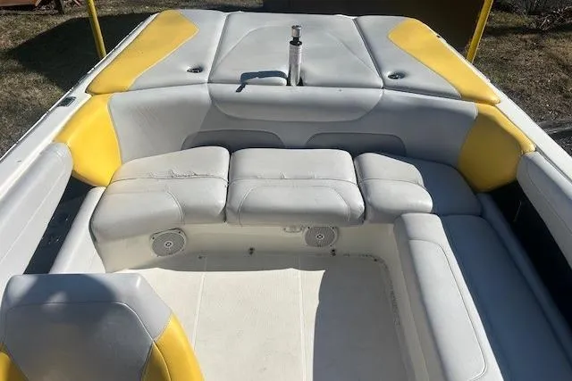Slide: The Image of 2004 Centurion Lightning boat interior with yellow and gray seating, open bow design. - 12