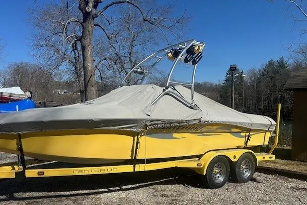 Slide: The Image of Yellow 2004 Centurion Lightning boat on trailer, covered, parked outdoors. - 14