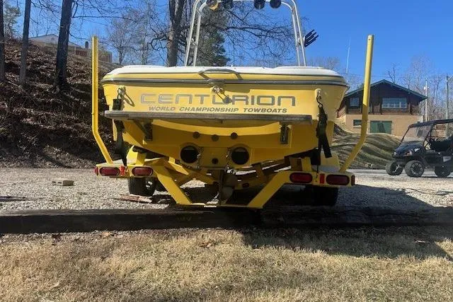 Slide: The Image of Yellow 2004 Centurion Lightning boat on trailer, parked outdoors. - 3