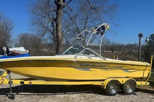 Slide: The Image of Yellow 2004 Centurion Lightning boat on trailer, parked outdoors on a sunny day. - 5