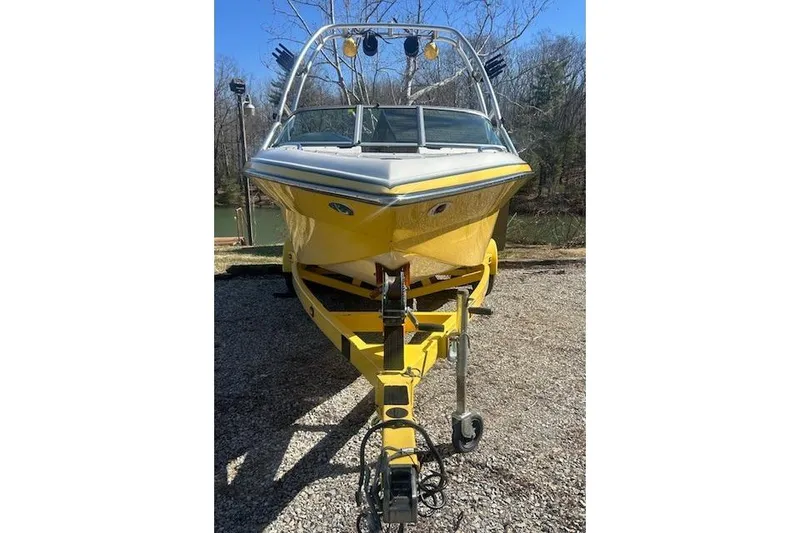 Slide: The Image of Yellow 2004 Centurion Lightning boat on trailer, parked outdoors. - 6