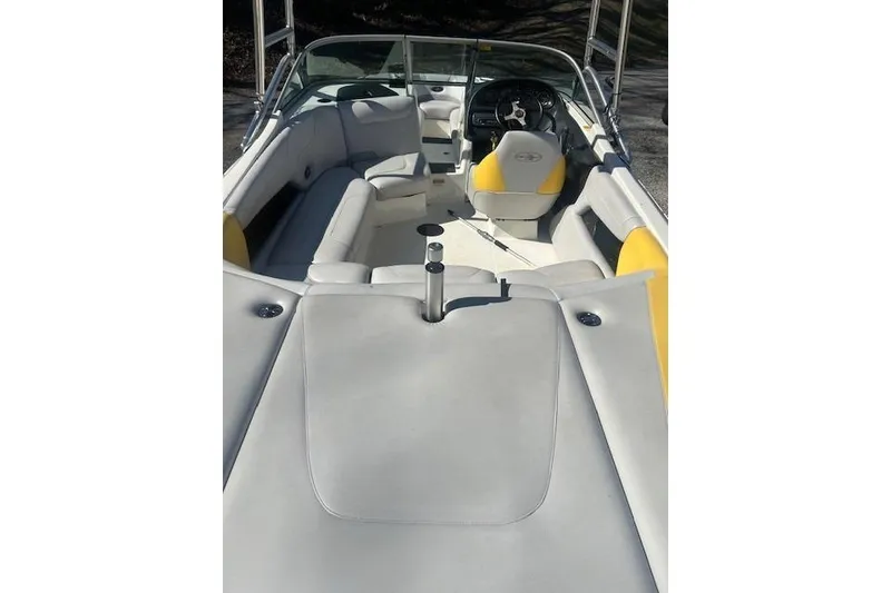Slide: The Image of 2004 Centurion Lightning boat interior with yellow and white seating, steering wheel visible. - 7