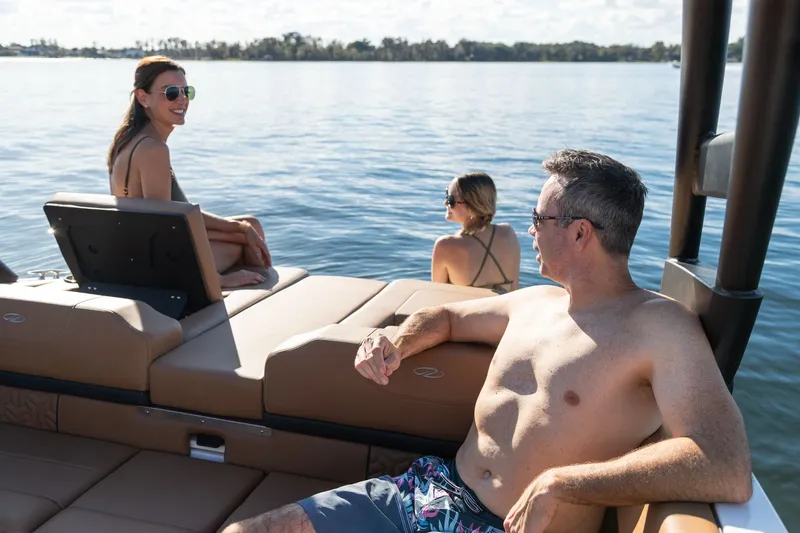 Slide: The Image of 2026 Regal LS2 Surf Ultimate boat on calm water with passengers. - 29