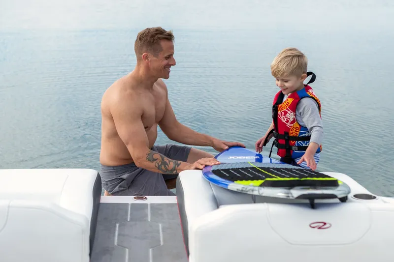 Slide: The Image of Father and child on Regal LS2 Surf Ultimate 2026 by the water. - 35