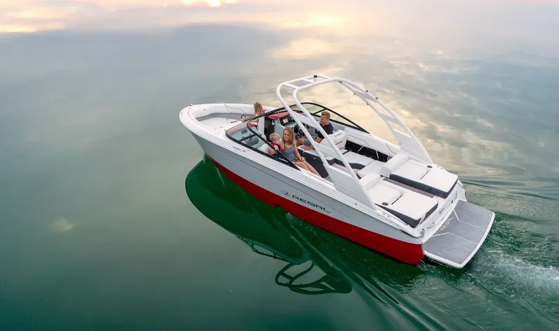 Slide: The Image of 2026 Regal LS2 Surf Ultimate boat on a river under a bridge. - 6