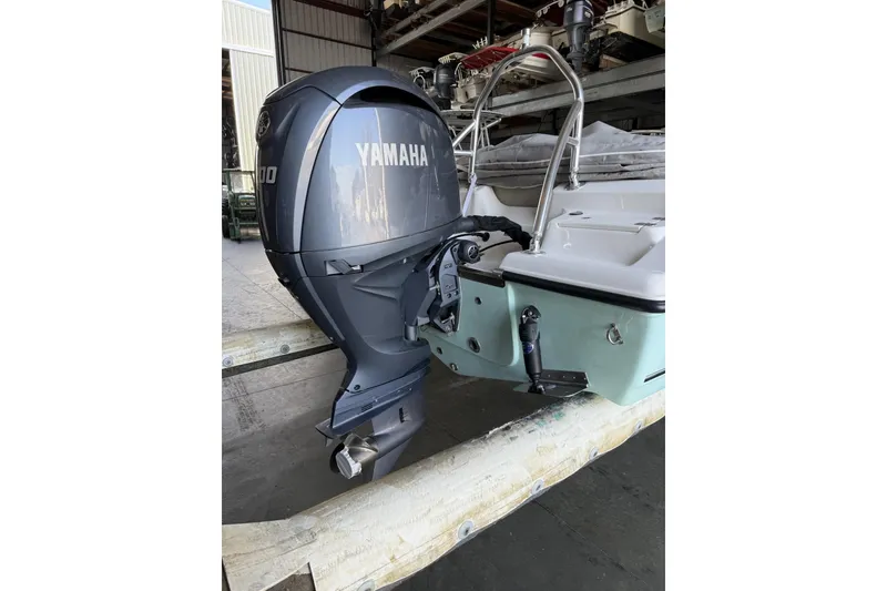 Slide: The Image of 2024 Key West 203 DFS boat with Yamaha outboard motor in a storage facility. - 3