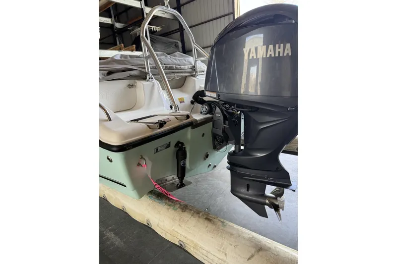 Slide: The Image of 2024 Key West 203 DFS boat with Yamaha outboard motor in storage. - 6