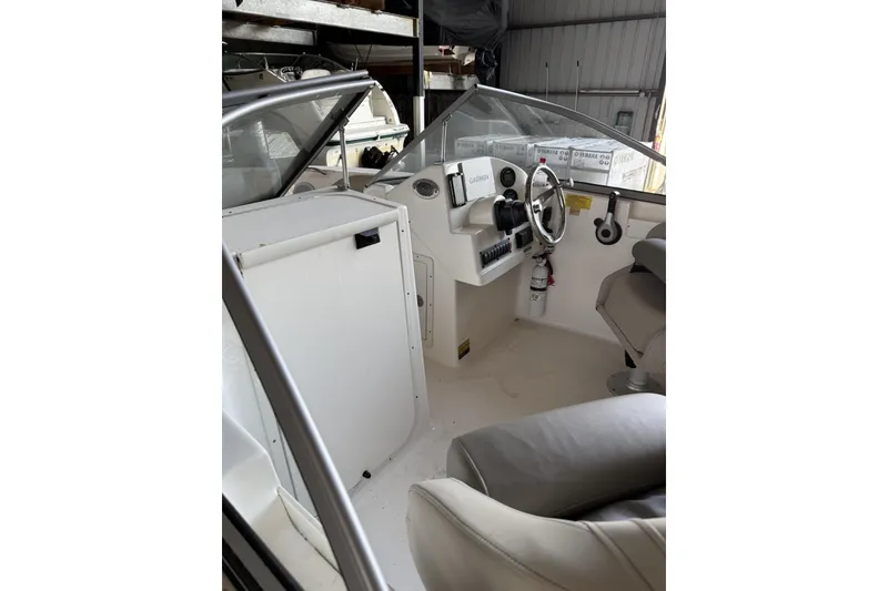Slide: The Image of 2024 Key West 203 DFS boat interior with steering wheel and seating. - 7