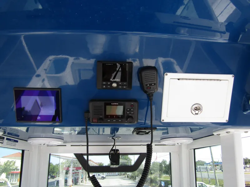 Slide: The Image of 2024 Wellcraft 263 Fisherman boat dashboard with navigation and communication equipment. - 22