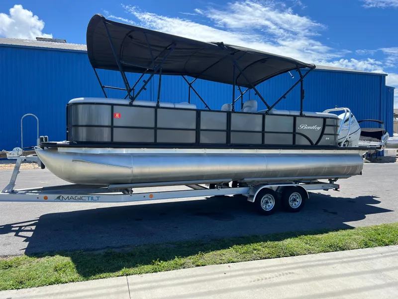 The Image of 2023 Bentley Pontoons 243 Navigator on trailer, blue sky. - 0