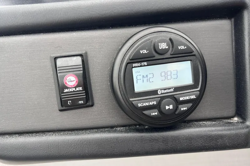 Slide: The Image of Control panel of 2023 Bentley Pontoons 243 Navigator with JBL radio and jackplate switch. - 13