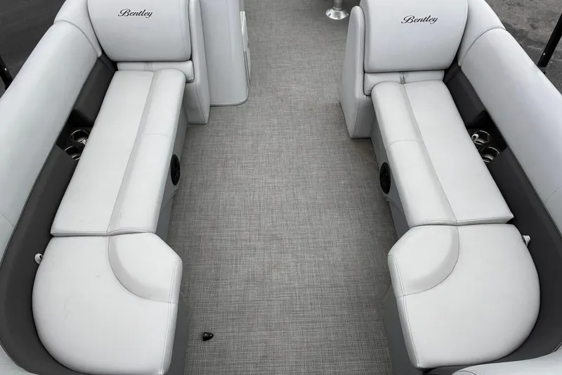 Slide: The Image of 2023 Bentley Pontoons 243 Navigator interior with luxurious white seating and cup holders. - 16