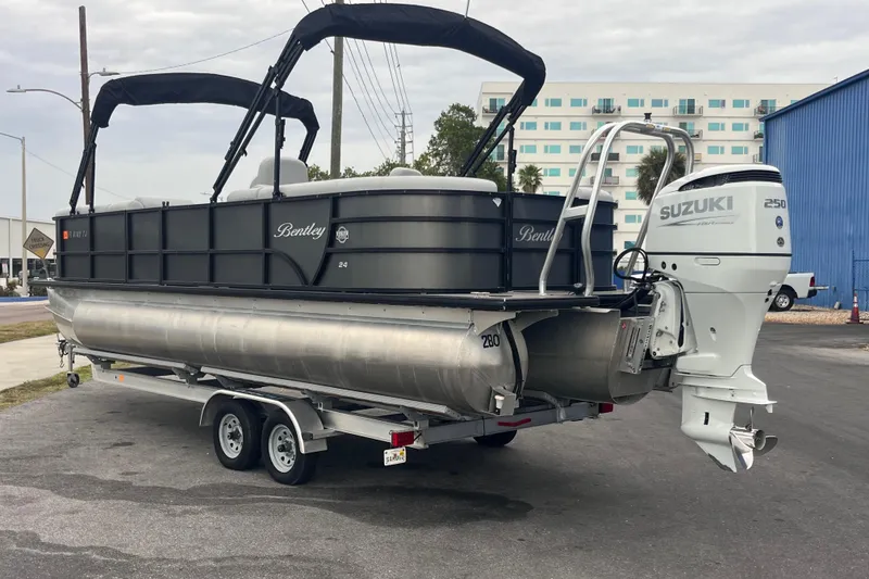 Slide: The Image of 2023 Bentley Pontoons 243 Navigator with Suzuki 250 outboard motor on trailer. - 2