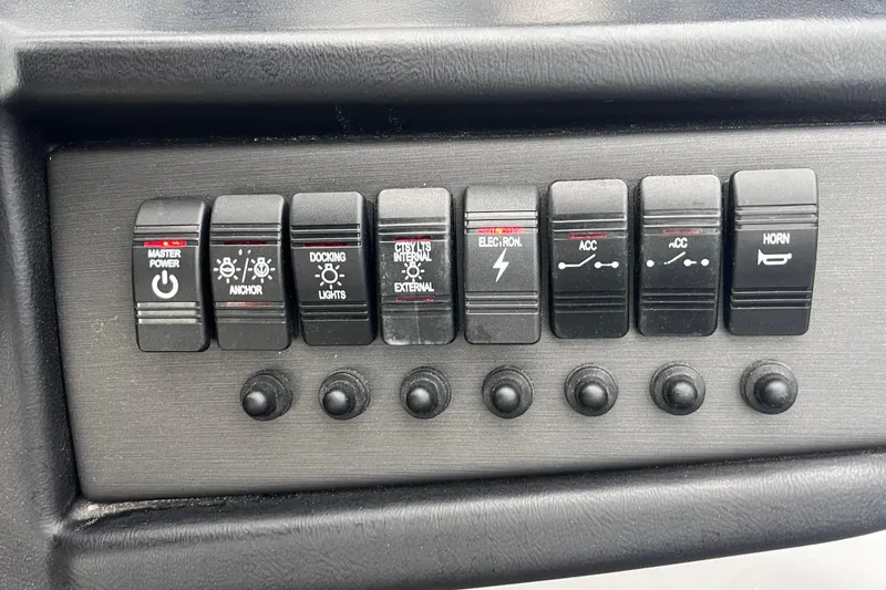 Slide: The Image of Control panel of 2023 Bentley Pontoons 243 Navigator with various switches and buttons. - 23