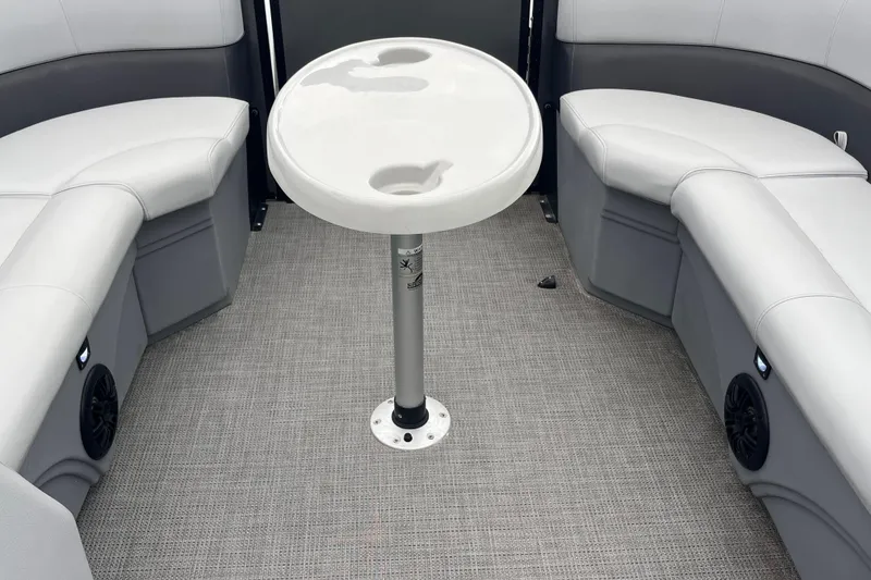 Slide: The Image of 2023 Bentley Pontoons 243 Navigator interior with round table and cushioned seating. - 24