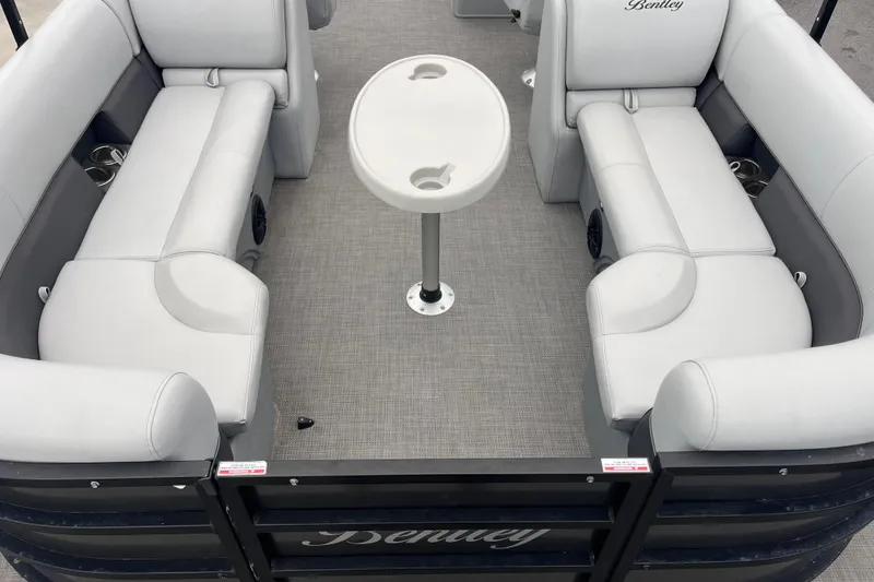 Slide: The Image of 2023 Bentley Pontoons 243 Navigator interior with gray seating and central table. - 26