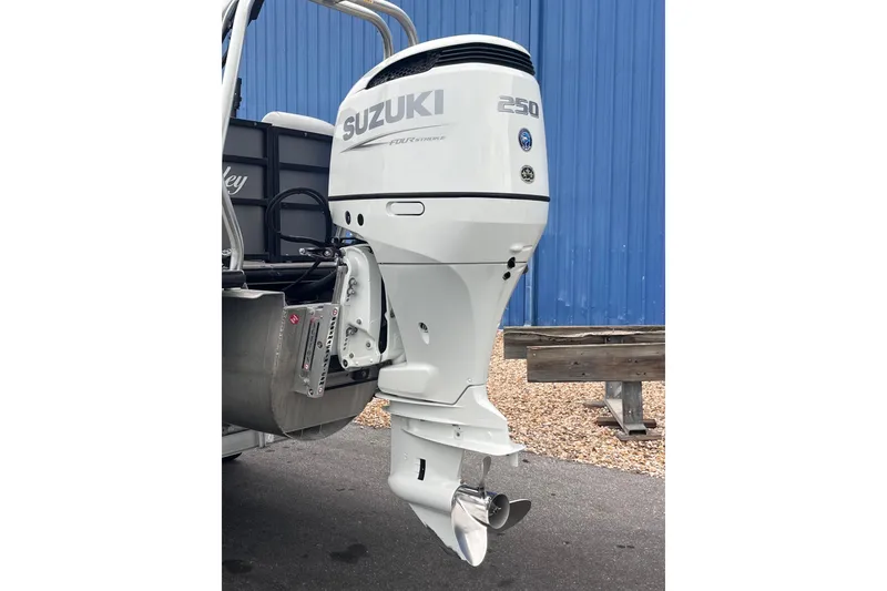 Slide: The Image of 2023 Bentley Pontoons 243 Navigator with Suzuki 250 outboard motor, blue background. - 7