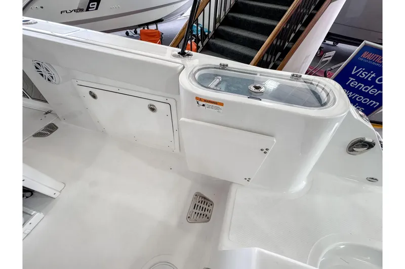 Slide: The Image of 2024 Wellcraft 263 Fisherman boat interior with storage compartments and livewell. - 10