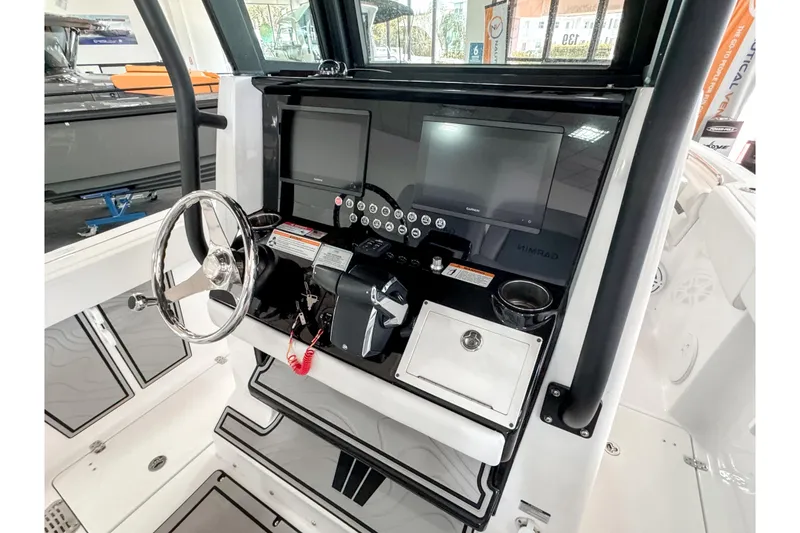 Slide: The Image of 2024 Wellcraft 263 Fisherman boat dashboard with steering wheel and modern navigation system. - 13