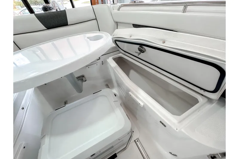 Slide: The Image of 2024 Wellcraft 263 Fisherman interior with storage compartments and seating area. - 16