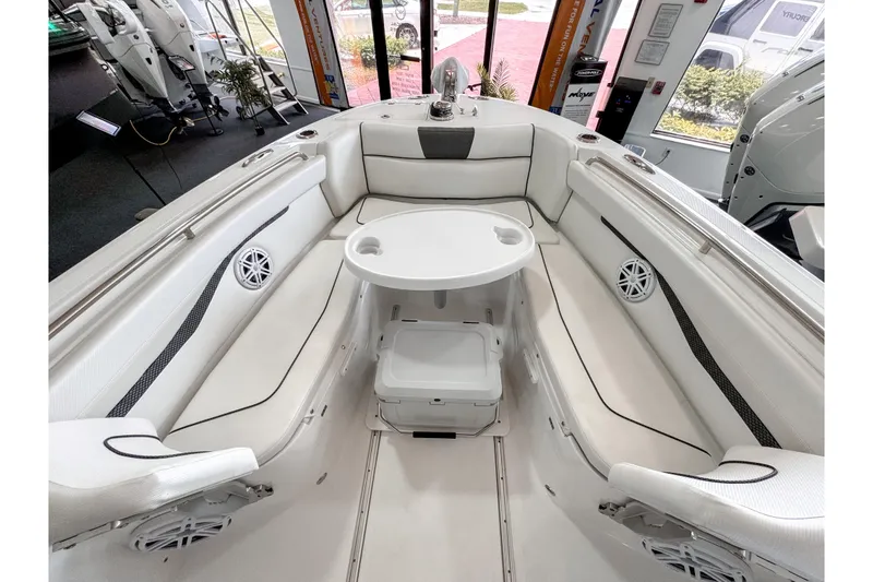 Slide: The Image of 2024 Wellcraft 263 Fisherman boat interior with white seating and round table. - 17