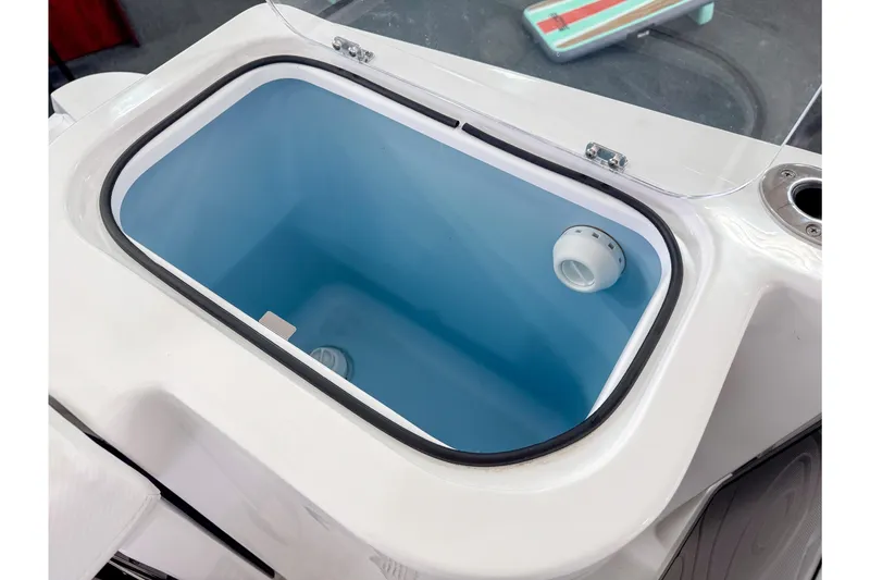 Slide: The Image of 2024 Wellcraft 263 Fisherman livewell, white and blue interior, open lid view. - 7