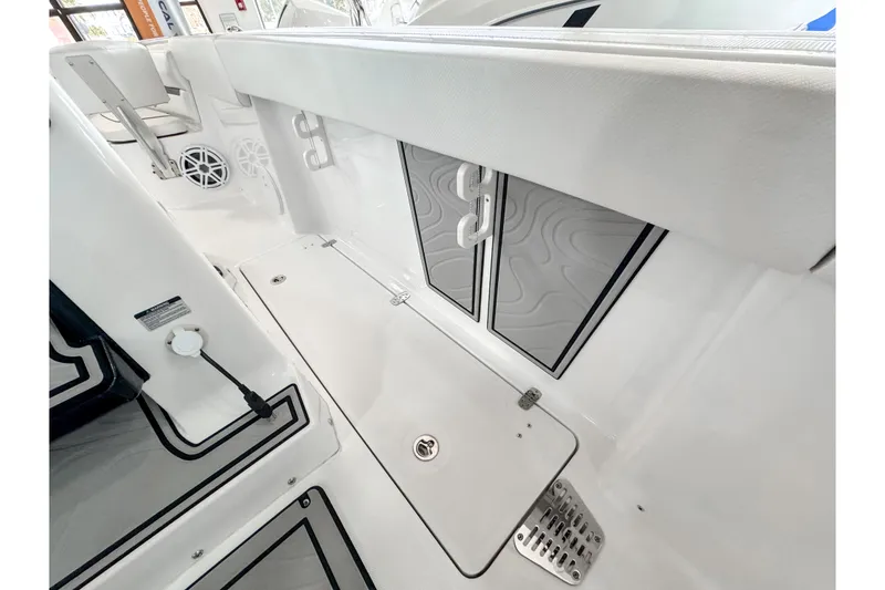 Slide: The Image of 2024 Wellcraft 263 Fisherman boat interior with storage compartments and seating area. - 11