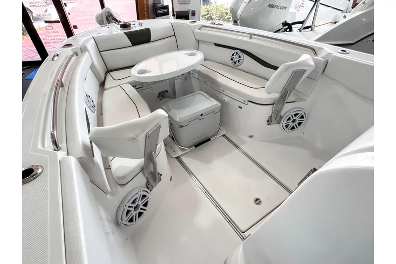Slide: The Image of 2024 Wellcraft 263 Fisherman boat interior with seating, table, and storage. - 14