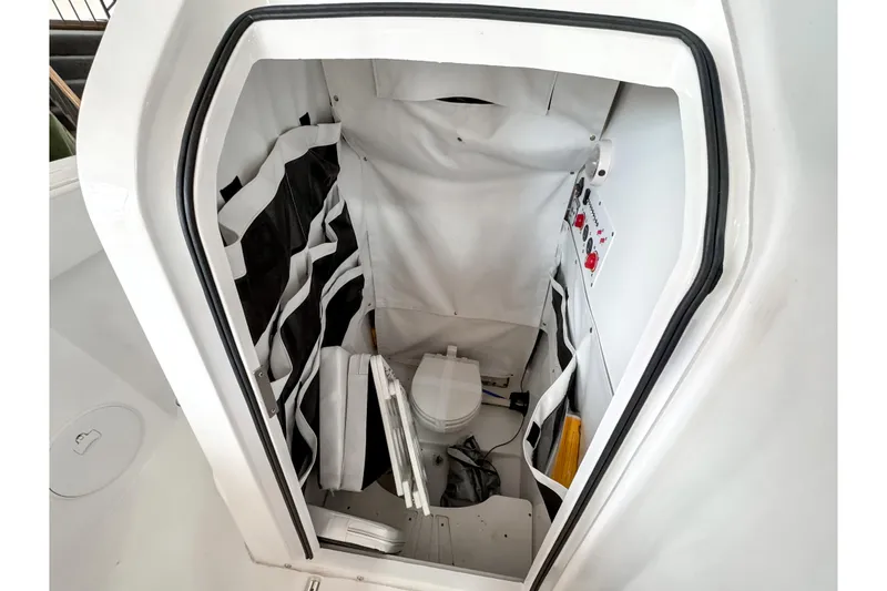 Slide: The Image of 2024 Wellcraft 263 Fisherman boat interior with compact marine toilet. - 20