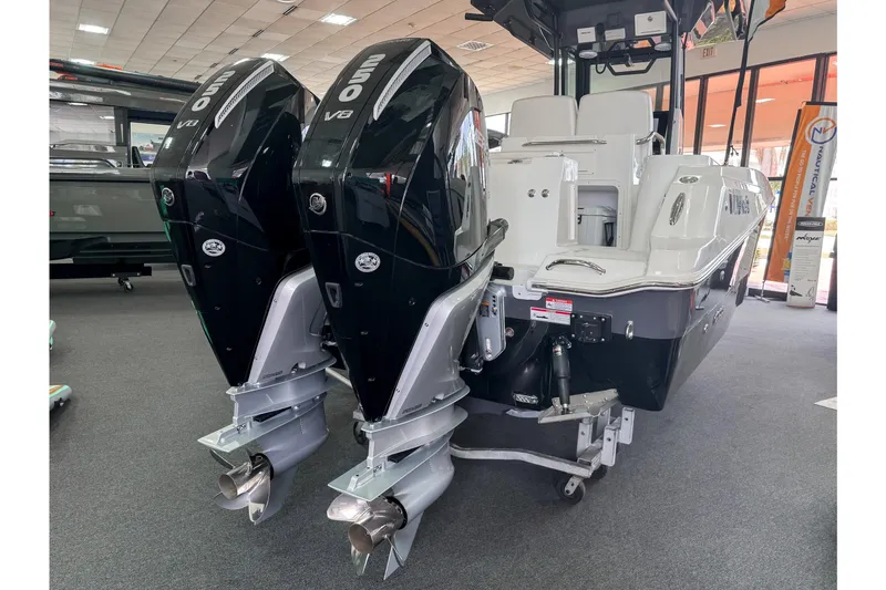 Slide: The Image of 2024 Wellcraft 263 Fisherman boat with dual outboard engines displayed indoors. - 3