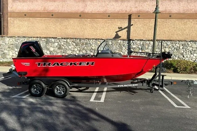 The Image of 2026 Tracker Targa V-18 WT boat in vibrant red, parked on a trailer. - 0
