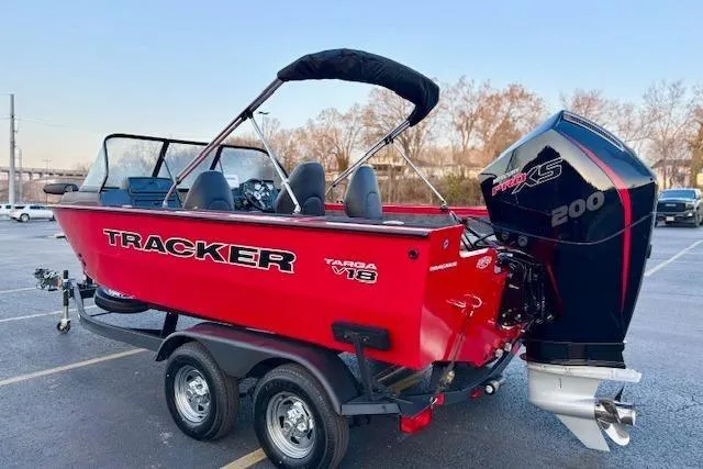 Slide: The Image of 2026 Tracker Targa V-18 WT boat with powerful 200 HP engine, parked on a trailer. - 2
