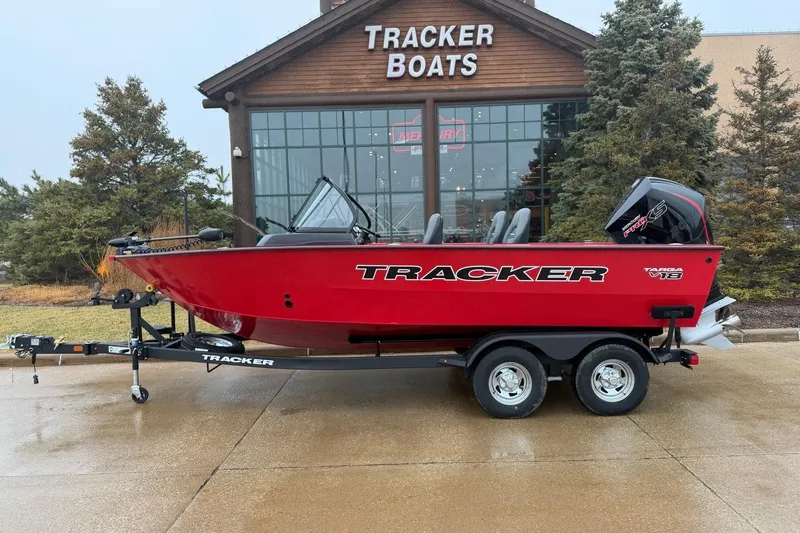 The Image of 2026 Tracker Targa V-18 WT boat in red, parked outside Tracker Boats showroom. - 0