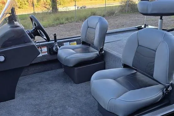 Slide: The Image of 2026 Tracker Bass Tracker Classic XL boat interior with gray seating and steering console. - 3