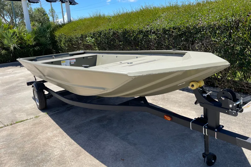 Slide: The Image of 2026 Tracker Grizzly 1648 Utility boat on trailer, parked outdoors. - 3
