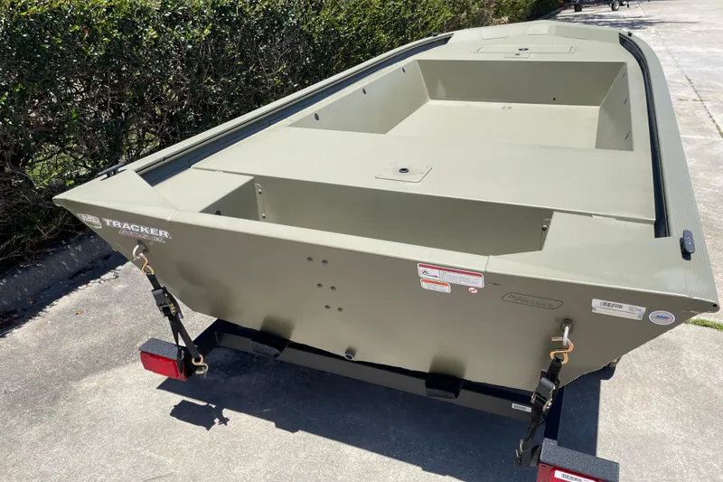 Slide: The Image of 2026 Tracker Grizzly 1648 Utility boat on trailer, parked outdoors. - 4