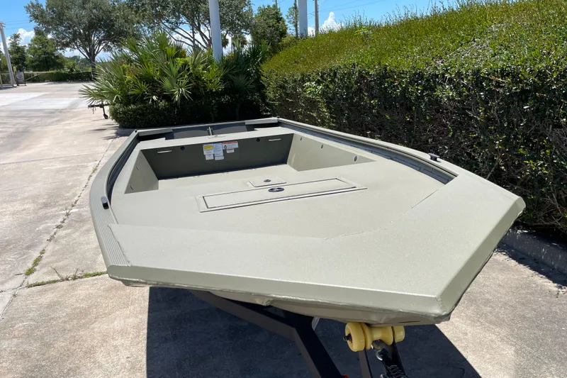 Slide: The Image of 2026 Tracker Grizzly 1648 Utility boat on trailer, parked outdoors. - 7