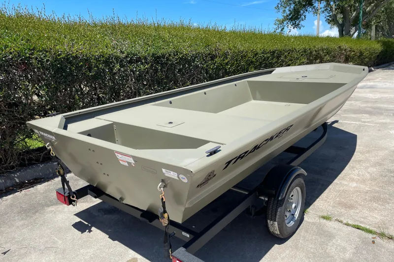 Slide: The Image of 2026 Tracker Grizzly 1648 Utility boat on trailer, parked outdoors. - 2