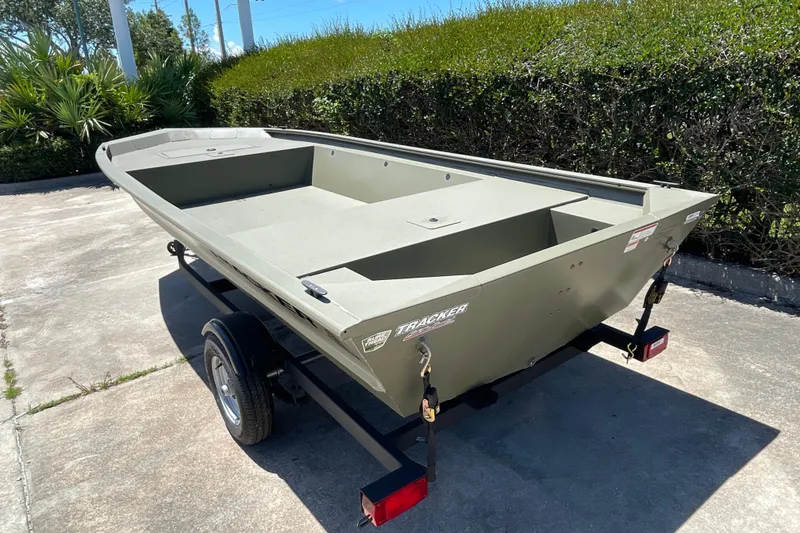 Slide: The Image of 2026 Tracker Grizzly 1648 Utility boat on trailer, parked outdoors. - 6