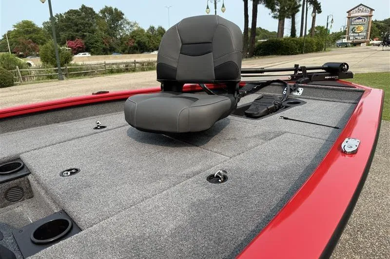 Slide: The Image of 2026 Tracker Pro Team 175 boat with gray seating and red trim, parked outdoors. - 6