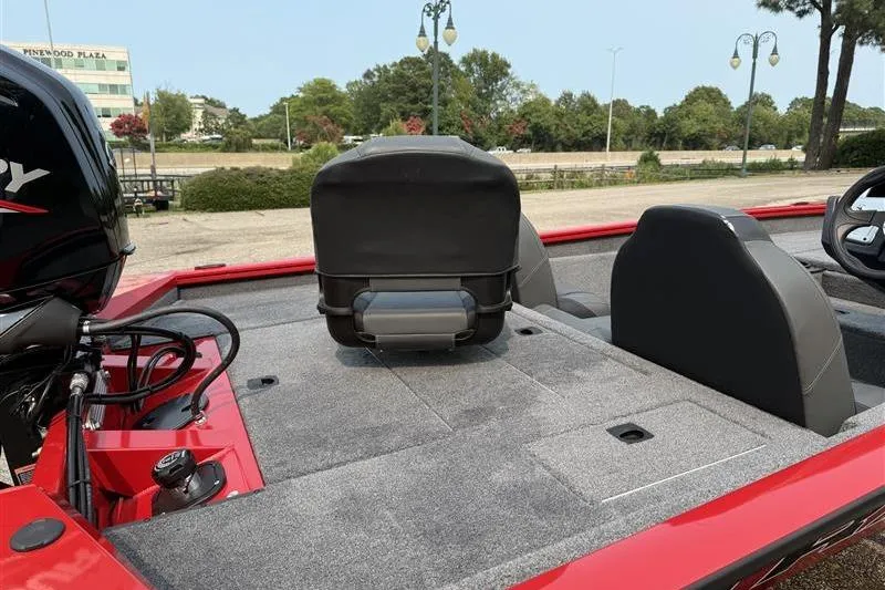 Slide: The Image of 2026 Tracker Pro Team 175 boat interior with seating and motor, parked outdoors. - 11