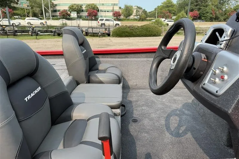 Slide: The Image of 2026 Tracker Pro Team 175 boat interior with gray seats and steering wheel. - 8