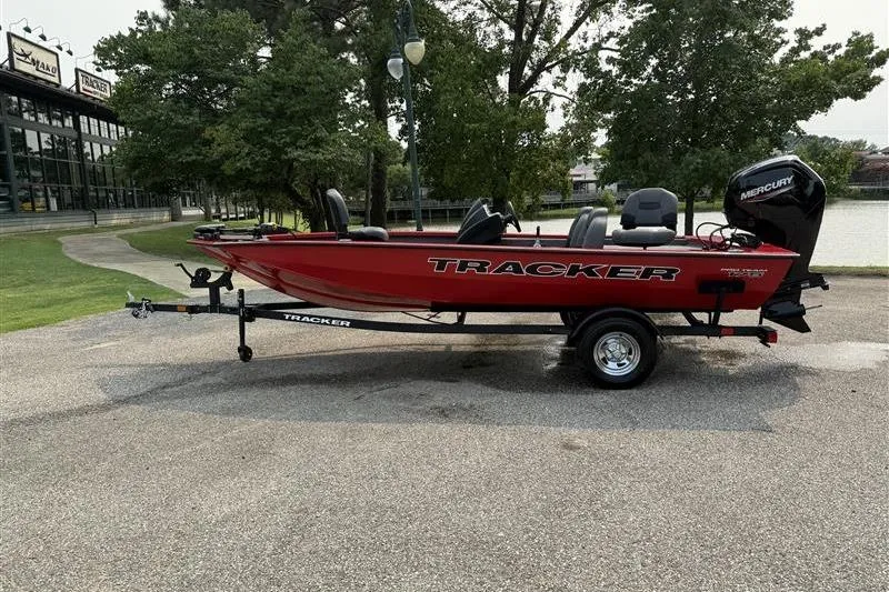 The Image of 2026 Tracker Pro Team 175 boat in red, parked outdoors on a trailer. - 0