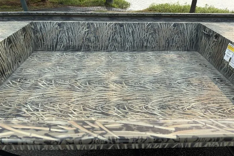 Slide: The Image of 2026 Tracker Grizzly 1648 Utility boat with camouflage interior design. - 13