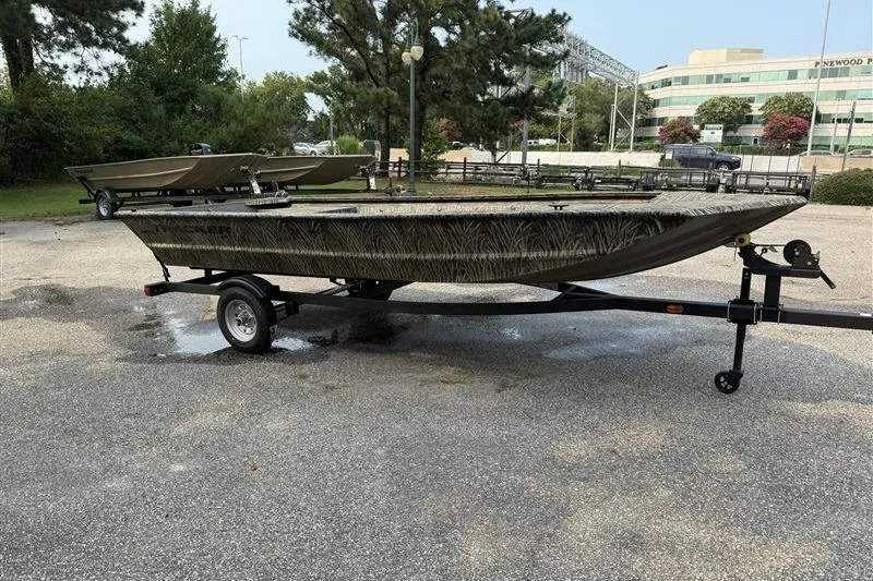 Slide: The Image of 2026 Tracker Grizzly 1648 Utility boat on trailer in parking lot. - 6