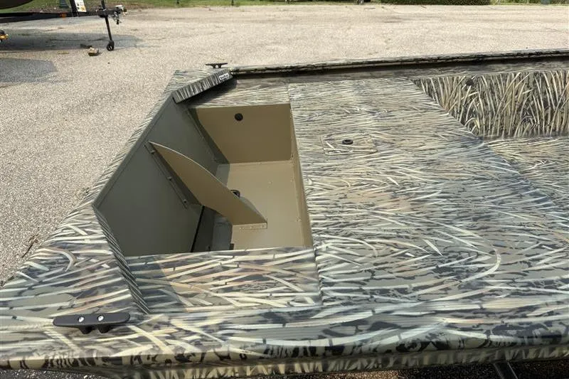 Slide: The Image of 2026 Tracker Grizzly 1648 Utility boat with camo design and open storage compartment. - 10
