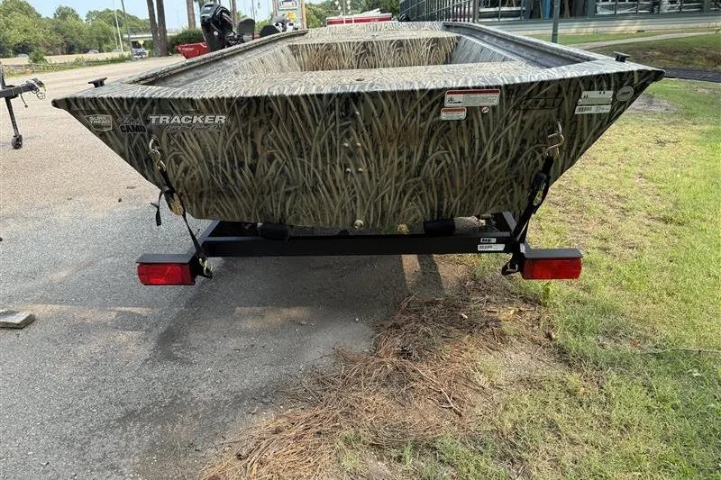 Slide: The Image of 2026 Tracker Grizzly 1648 Utility boat with camouflage design on a trailer. - 4