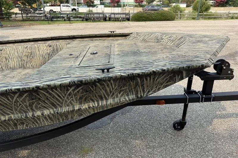 Slide: The Image of 2026 Tracker Grizzly 1648 Utility boat with camouflage design on a trailer. - 7